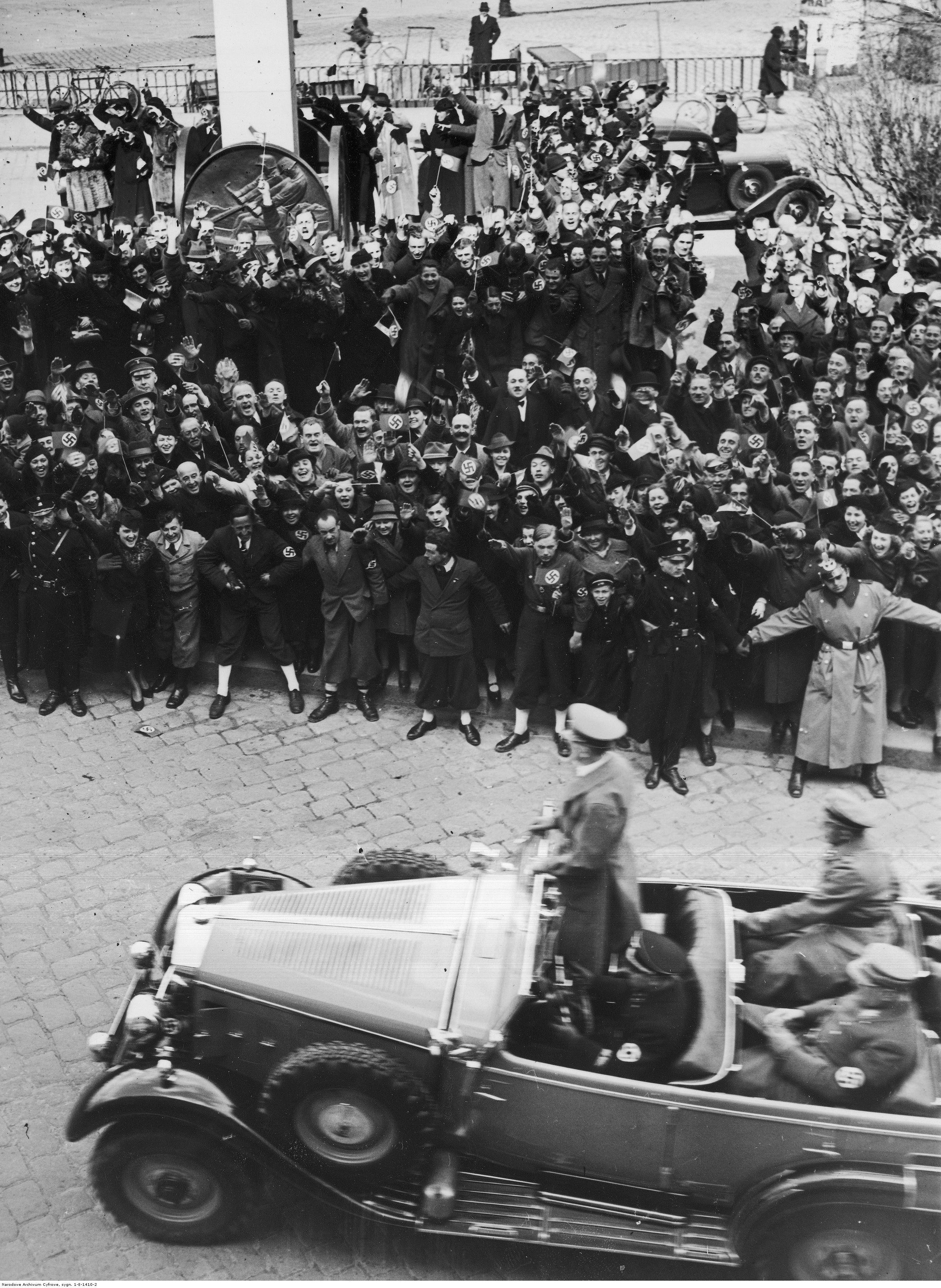 Adolf Hitler is greeted by the crowd as he crosses Linz